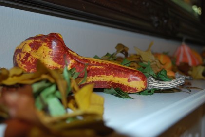 gourds and leaves on white mantle